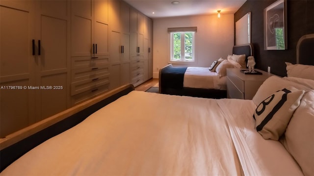 bedroom with recessed lighting and wood finished floors