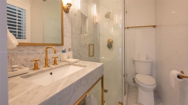 bathroom featuring toilet, tile walls, a shower stall, tasteful backsplash, and vanity