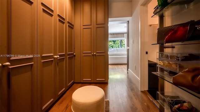 bathroom featuring wood finished floors and baseboards