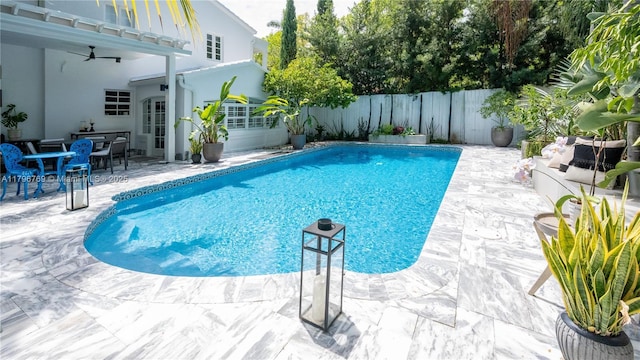 view of swimming pool with ceiling fan, a patio, a fenced in pool, and a fenced backyard