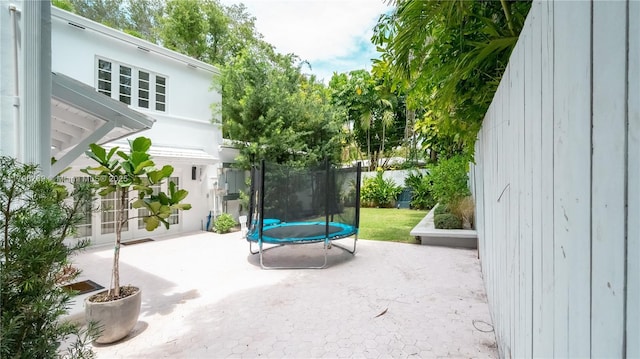 view of patio / terrace featuring a trampoline and fence