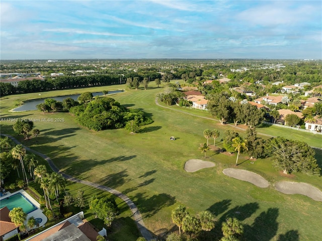 drone / aerial view with view of golf course, a water view, and a residential view