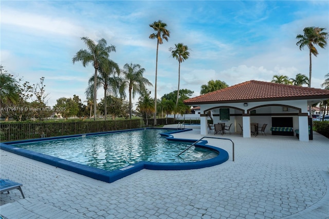 community pool featuring a patio and fence