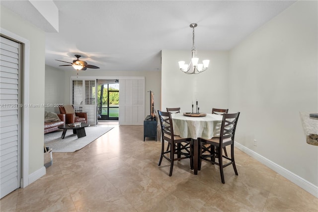 dining space featuring baseboards, light tile patterned floors, and ceiling fan with notable chandelier