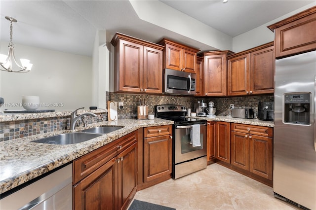 kitchen featuring stainless steel appliances, tasteful backsplash, light stone countertops, and a sink