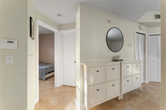 hallway with light tile patterned flooring and visible vents