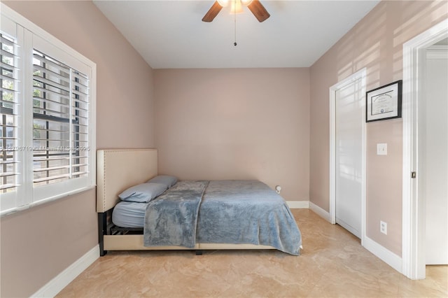 bedroom featuring baseboards and a ceiling fan