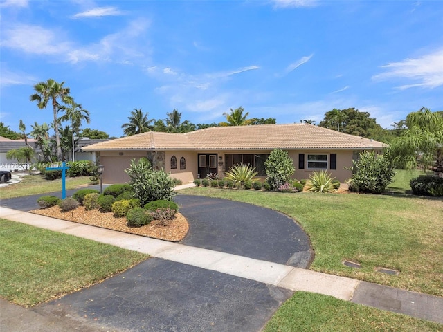 5101 N 37th St, Hollywood, FL 33021 - ranch-style house with driveway, stucco siding, a tile roof, and a front yard