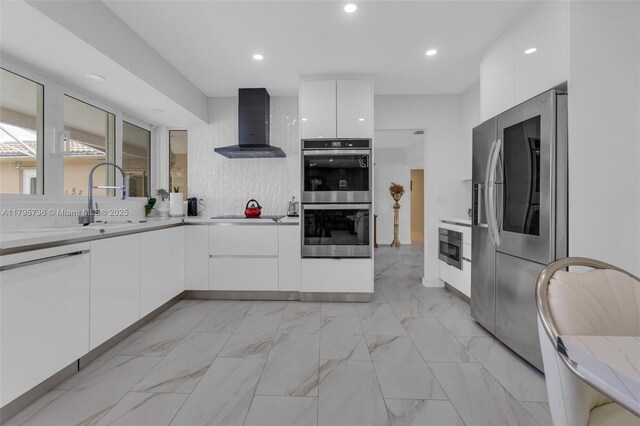 5101 N 37th St, Hollywood, FL 33021 - kitchen with wall chimney exhaust hood, white cabinets, modern cabinets, and appliances with stainless steel finishes