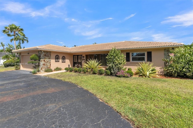 5101 N 37th St, Hollywood, FL 33021 - single story home featuring a front lawn, stucco siding, a tile roof, and driveway