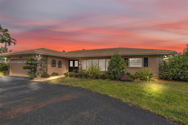 5101 N 37th St, Hollywood, FL 33021 - single story home with aphalt driveway, stucco siding, a front lawn, and a tiled roof