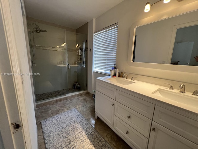 full bathroom featuring a sink, double vanity, and a stall shower