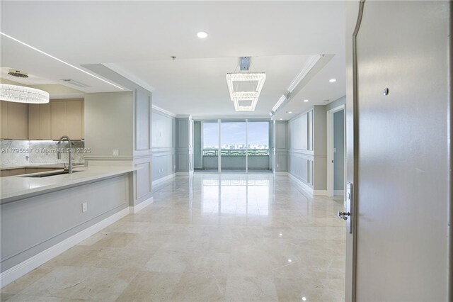 3400 SW 27th Ave Unit 1506, Miami, FL 33133 - spare room with ornamental molding, a chandelier, and a decorative wall
