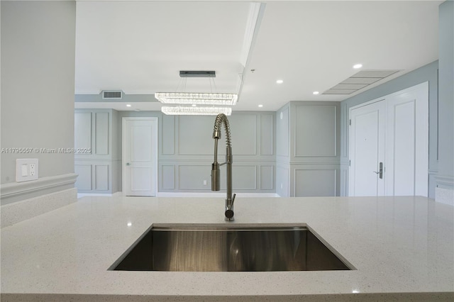 3400 SW 27th Ave Unit 1506, Miami, FL 33133 - kitchen view of light stone counters, a decorative wall, decorative light fixtures, and recessed lighting