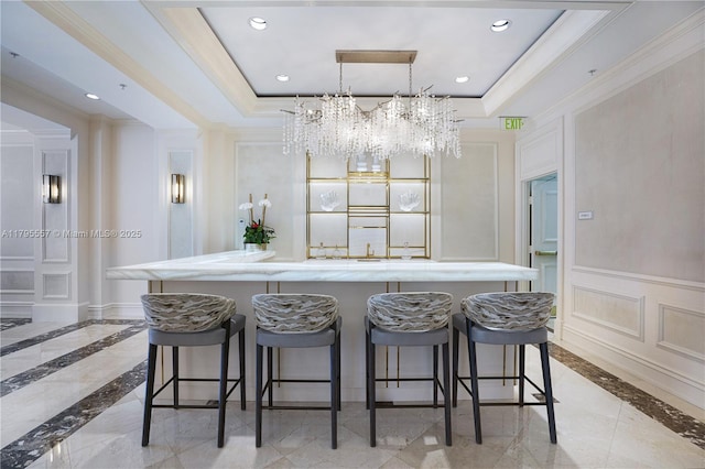 3400 SW 27th Ave Unit 1506, Miami, FL 33133 - bar with a tray ceiling, a chandelier, a decorative wall, and ornamental molding
