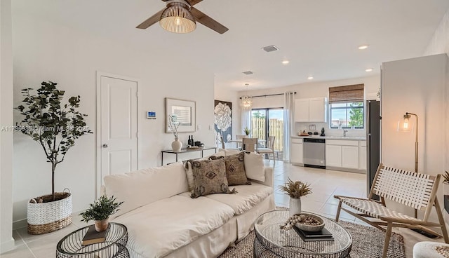 living room with light tile patterned floors, a ceiling fan, visible vents, and recessed lighting