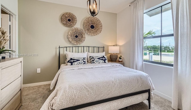 bedroom with carpet flooring, baseboards, and multiple windows