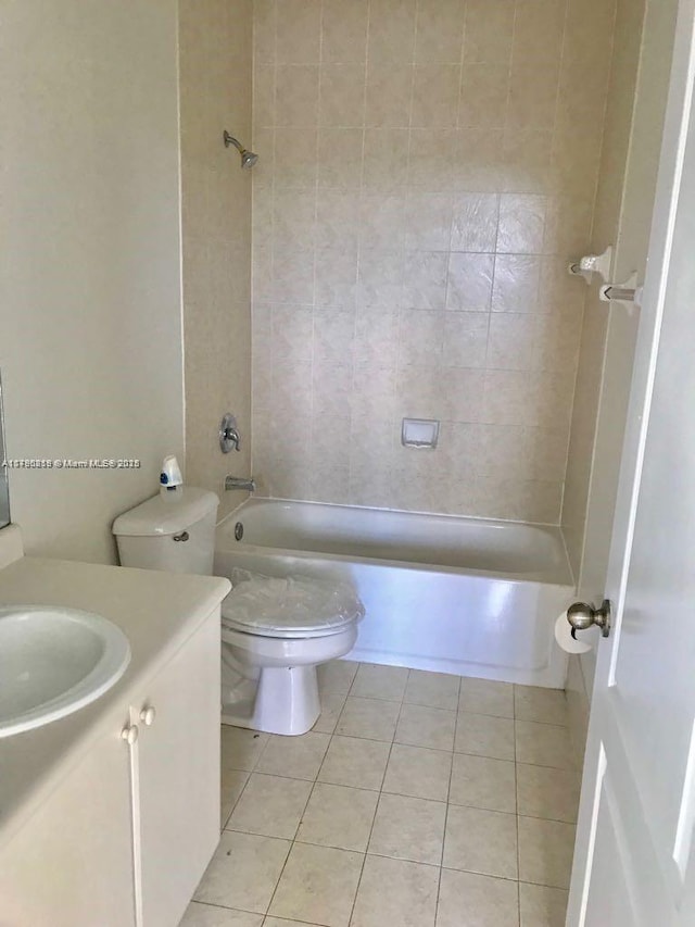 full bathroom featuring tile patterned flooring, toilet, washtub / shower combination, and vanity
