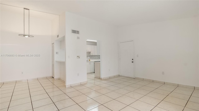 20680 NE 4th Ct Unit 206, Miami, FL 33179 - empty room featuring visible vents, light tile patterned flooring, and a towering ceiling