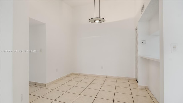 empty room featuring visible vents and light tile patterned flooring