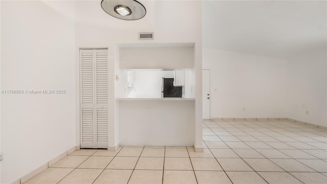 interior space featuring light tile patterned flooring and visible vents