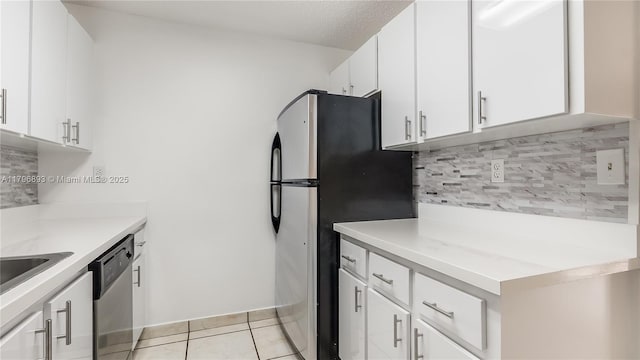 20680 NE 4th Ct Unit 206, Miami, FL 33179 - kitchen with stainless steel appliances, white cabinetry, decorative backsplash, light countertops, and light tile patterned floors