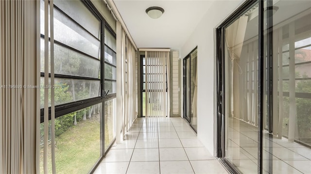 20680 NE 4th Ct Unit 206, Miami, FL 33179 - corridor featuring light tile patterned floors and a wall of windows