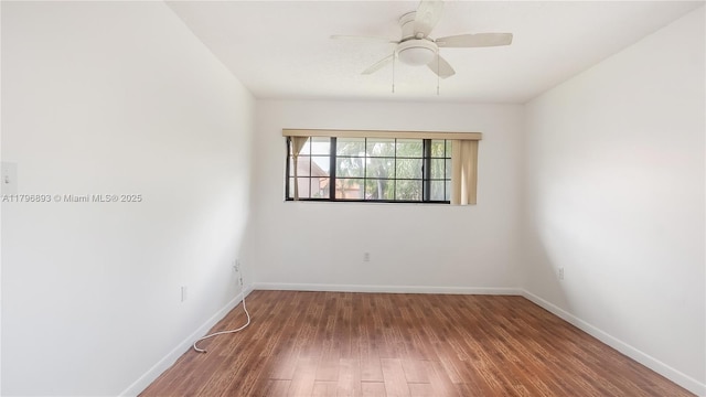 spare room featuring ceiling fan, baseboards, and wood finished floors