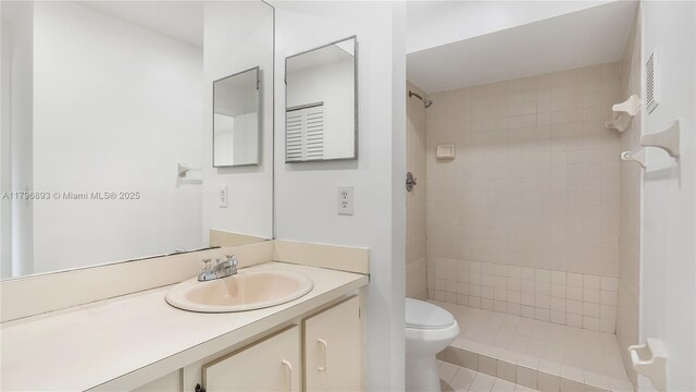 20680 NE 4th Ct Unit 206, Miami, FL 33179 - full bathroom featuring vanity, toilet, tile patterned flooring, and a tile shower