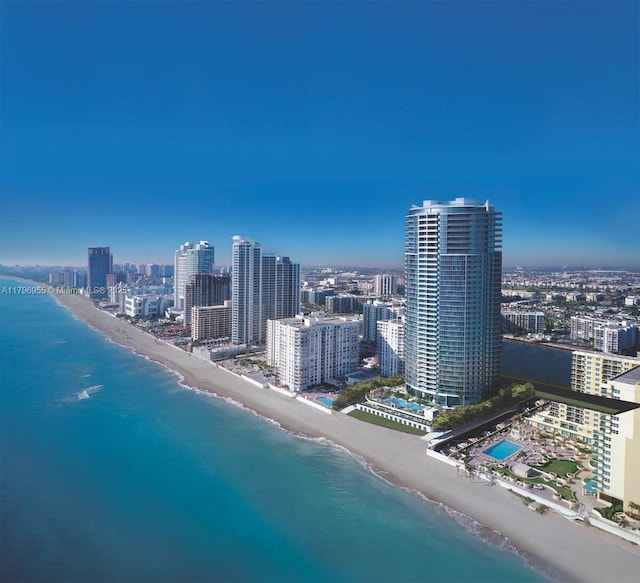 bird's eye view with a city view, a water view, and a beach view