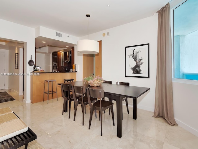dining space featuring baseboards and visible vents