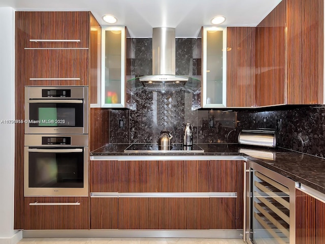 kitchen featuring beverage cooler, modern cabinets, island range hood, decorative backsplash, and black electric stovetop