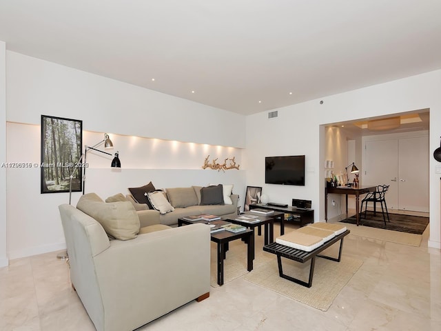 living room with marble finish floor and visible vents