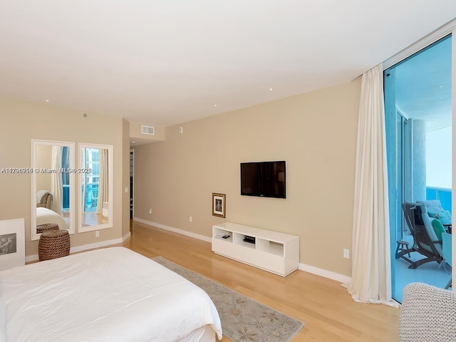 bedroom featuring light wood finished floors, multiple windows, and visible vents