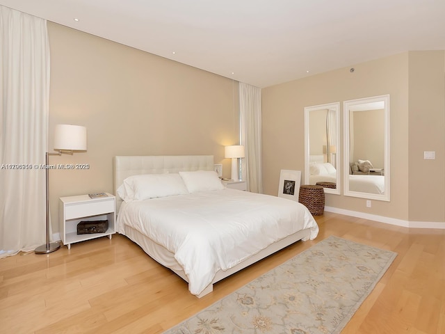 bedroom with baseboards, light wood-style flooring, and recessed lighting