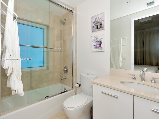 full bath featuring toilet, vanity, visible vents, and shower / bath combination with glass door