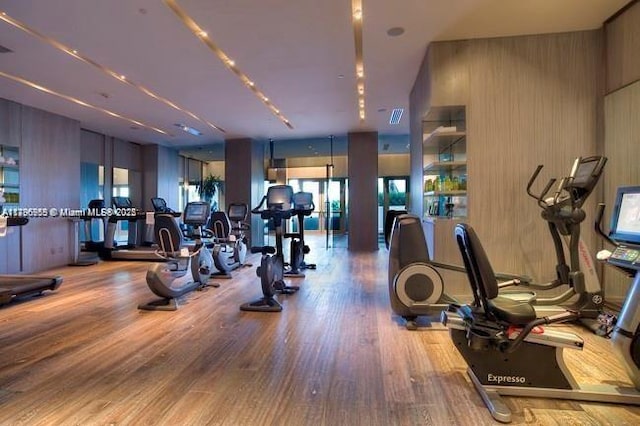 exercise room with visible vents and wood finished floors