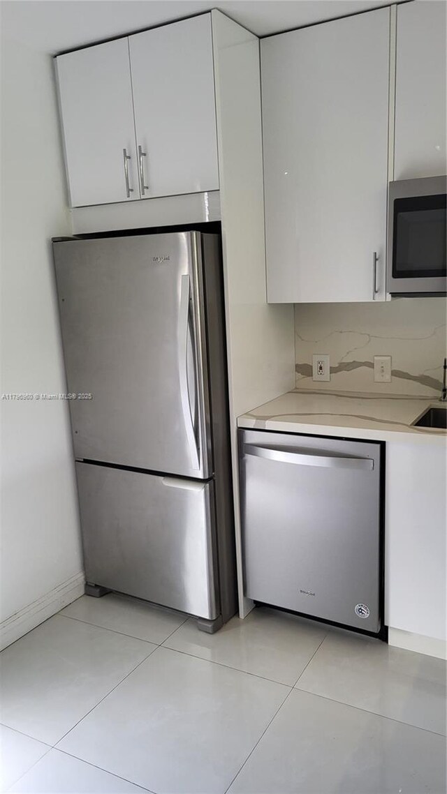 3401 N Country Club Dr Unit 410, Aventura, FL 33180 - kitchen featuring a sink, white cabinetry, light countertops, modern cabinets, and appliances with stainless steel finishes