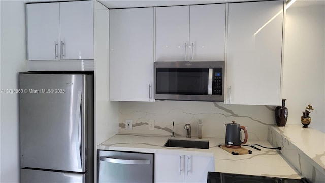 3401 N Country Club Dr Unit 410, Aventura, FL 33180 - kitchen featuring a sink, stainless steel appliances, backsplash, white cabinets, and modern cabinets
