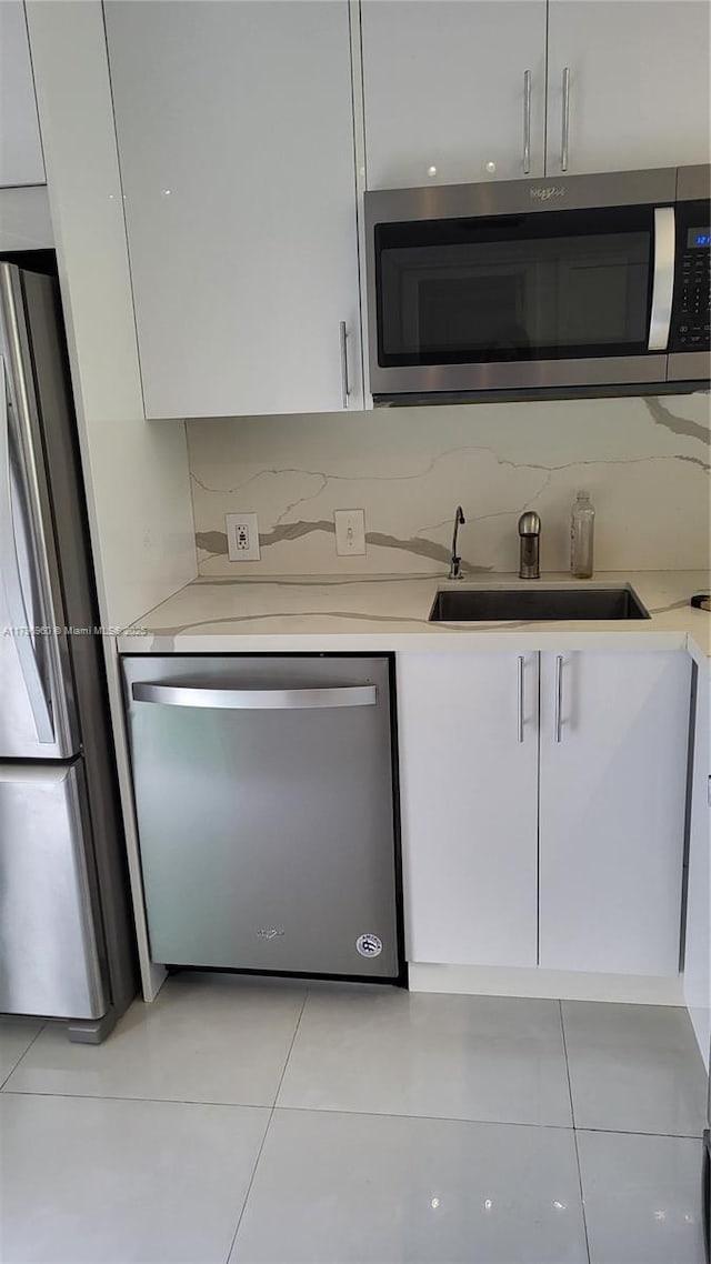 3401 N Country Club Dr Unit 410, Aventura, FL 33180 - kitchen featuring light countertops, white cabinets, appliances with stainless steel finishes, and a sink