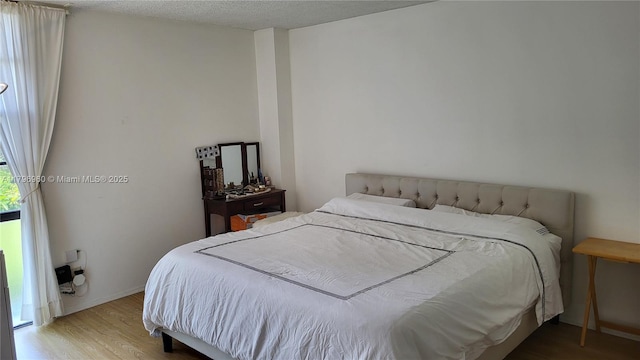 3401 N Country Club Dr Unit 410, Aventura, FL 33180 - bedroom with baseboards and wood finished floors