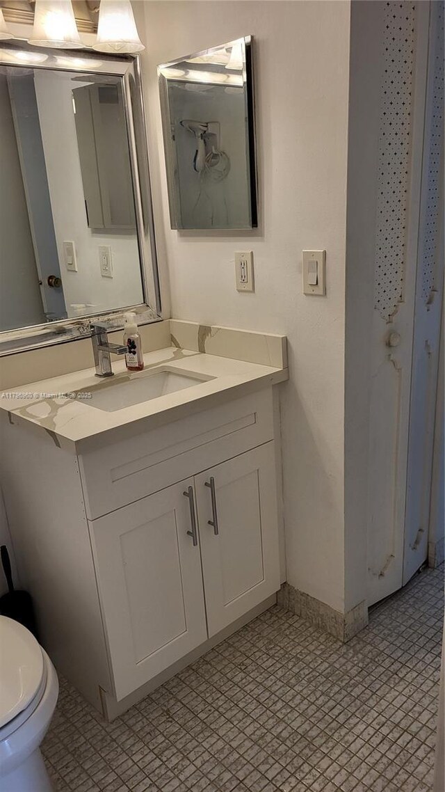 3401 N Country Club Dr Unit 410, Aventura, FL 33180 - bathroom with vanity, toilet, baseboards, and tile patterned floors