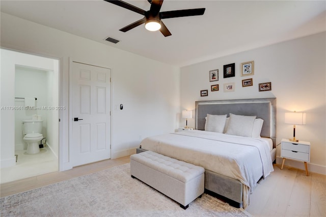 bedroom with ceiling fan, ensuite bath, baseboards, and visible vents