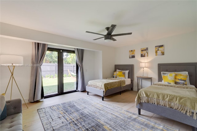 bedroom featuring access to outside, french doors, ceiling fan, and wood finished floors