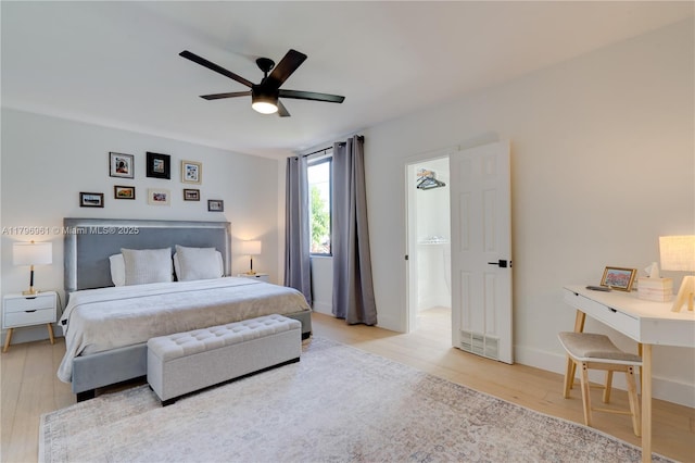 bedroom with ceiling fan, baseboards, and wood finished floors