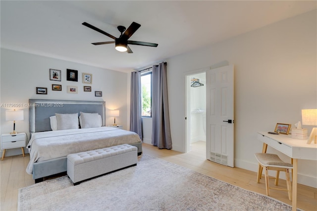 bedroom with ceiling fan, baseboards, and wood finished floors