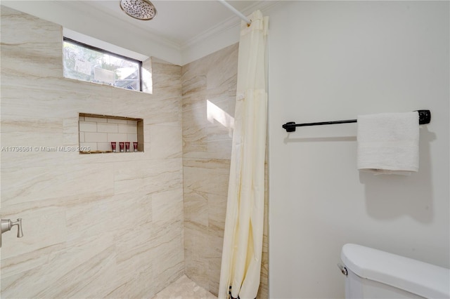 full bathroom with toilet, tiled shower, and ornamental molding