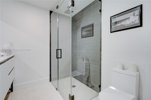 bathroom featuring vanity, toilet, tile patterned flooring, and a shower stall