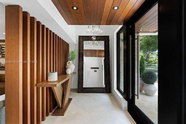doorway to outside featuring an inviting chandelier, recessed lighting, and wooden ceiling