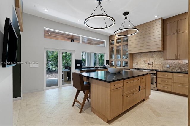 kitchen featuring dark countertops, tasteful backsplash, recessed lighting, and stainless steel range